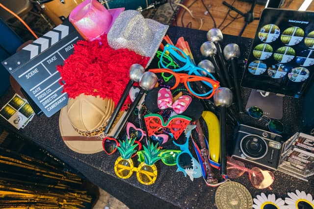 Event photo booth NYC setup with iPad touchscreen and colorful party props