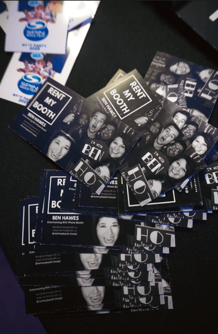 Custom-branded Rent My Booth photo prints and cards fanned out on a table